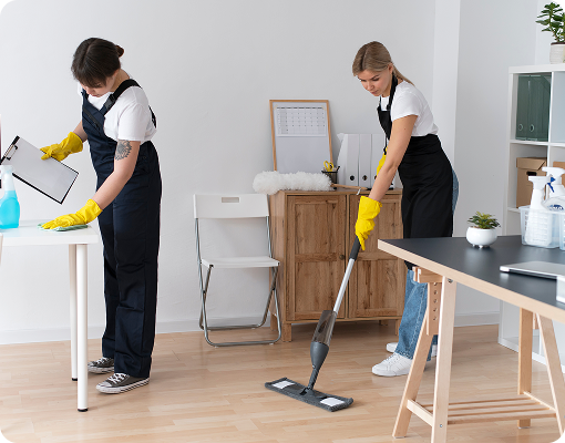 Small cleaning team coordinating tasks in an office setting.
