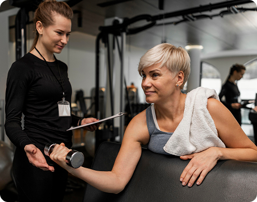 Independent personal trainer coaching a client in the gym.