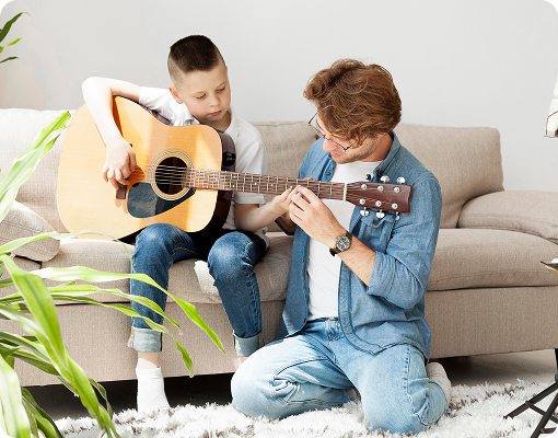 private music instructor teaching young student guitar during lesson